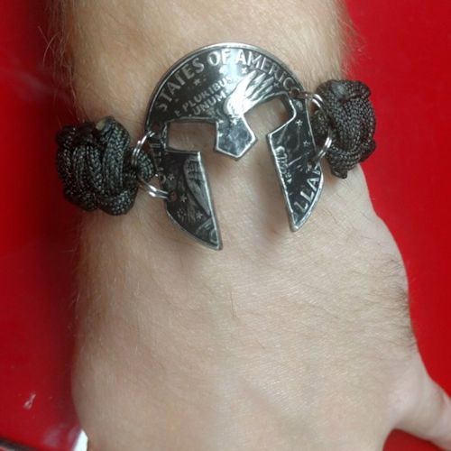 Spartan Mask cut Eisenhower Dollar paracord bracelet shown on wrist