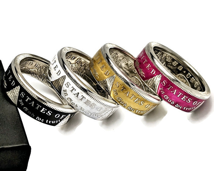 Colorized Morgan Silver Dollar coin rings in black, white, gold, and raspberry finishes