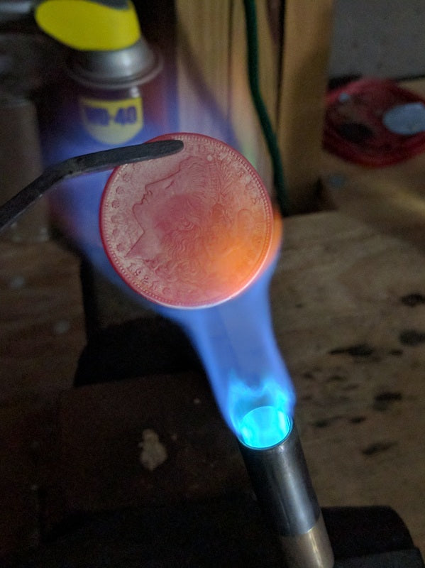 U.S. coin heated with a torch during the coin ring annealing process