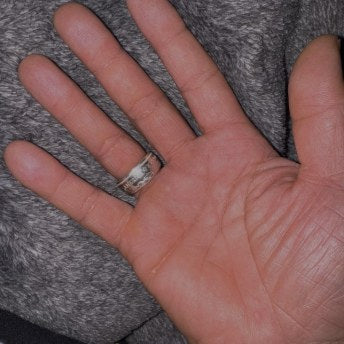 Customer wearing a wide silver CoinCrafters coin ring