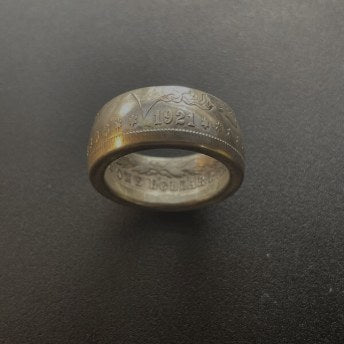 Customer wearing a silver CoinCrafters coin ring on an open hand