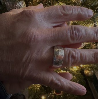 Customer wearing a handcrafted silver CoinCrafters coin ring